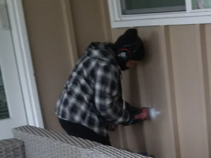 Professional electrician installing an exterior outlet in Carencro
